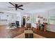 Open-concept living area with a view of the kitchen, showcasing hardwood floors and natural light at 1391 E Crooked Lake Dr, Eustis, FL 32726