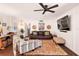 Comfortable living room with leather sofa, stylish armchair, and a modern ceiling fan at 1391 E Crooked Lake Dr, Eustis, FL 32726