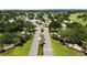 Aerial view of a neighborhood with lush landscaping, golf course, and stately entrance to Country Club Hills at 1501 W Schwartz Blvd, Lady Lake, FL 32159