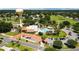 Aerial view of community with resort style pool with palm trees, on-site restaurant, and water tower at 1501 W Schwartz Blvd, Lady Lake, FL 32159