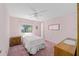 A pink bedroom with a ceiling fan and a quaint window at 1501 W Schwartz Blvd, Lady Lake, FL 32159