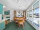 Inviting dining room featuring a chandelier and plenty of natural light from the adjacent wall of windows at 1501 W Schwartz Blvd, Lady Lake, FL 32159