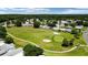 Scenic golf course view in a well-maintained community featuring mature trees and lush landscaping at 1501 W Schwartz Blvd, Lady Lake, FL 32159