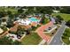 Aerial view of resort style pool with palm trees, chairs, waterfall feature, and on-site restaurant at 1501 W Schwartz Blvd, Lady Lake, FL 32159