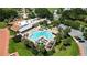 Aerial view of resort style pool with palm trees, chairs, waterfall feature, and on-site restaurant at 1501 W Schwartz Blvd, Lady Lake, FL 32159