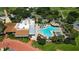 Aerial view of resort style pool with palm trees, chairs, waterfall feature, and on-site restaurant at 1501 W Schwartz Blvd, Lady Lake, FL 32159