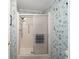 Bathroom features a shower stall with silver hardware and an easy to clean enclosure at 1501 W Schwartz Blvd, Lady Lake, FL 32159