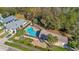 Aerial view of the community pool, amenities building, landscaping and surrounding homes at 16707 Broadford Ln, Clermont, FL 34714