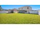 Spacious backyard with lush lawn, shed, and covered patio, great for outdoor living at 16707 Broadford Ln, Clermont, FL 34714