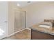 Bathroom featuring a granite counter with double sinks, tiled floors and glass enclosed shower at 16707 Broadford Ln, Clermont, FL 34714