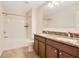 Bathroom boasts double vanity, tiled floors, and shower-tub combination at 16707 Broadford Ln, Clermont, FL 34714