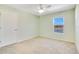 Bedroom featuring a ceiling fan, window view and neutral carpet, providing a blank canvas at 16707 Broadford Ln, Clermont, FL 34714