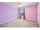 Cozy bedroom with carpet, a window view of the waterfront, and a ceiling fan at 16707 Broadford Ln, Clermont, FL 34714