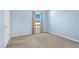 Blue bedroom with carpet, a window with curtains, and a white door at 16707 Broadford Ln, Clermont, FL 34714