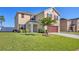 Two-story home features manicured lawn, mature landscaping, and a two car garage at 16707 Broadford Ln, Clermont, FL 34714