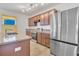 Well-lit kitchen features a granite countertop island and stainless steel appliances at 16707 Broadford Ln, Clermont, FL 34714