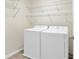 Laundry room features a modern washer and dryer with convenient wire shelving for organization at 16707 Broadford Ln, Clermont, FL 34714