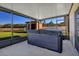Relaxing screened patio featuring a modern hot tub and view of the expansive backyard and pond at 16707 Broadford Ln, Clermont, FL 34714