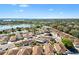 Wide aerial view of home in a neighborhood close to green trees and bodies of water at 1685 Garcia Ct, The Villages, FL 32159