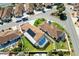 Aerial view of a home with a private pool, solar panels, and manicured landscaping at 1685 Garcia Ct, The Villages, FL 32159