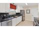 Updated kitchen featuring white cabinets, stainless steel appliances, and black granite countertops at 1685 Garcia Ct, The Villages, FL 32159