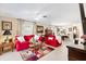 Bright living room with tile floors, large windows, and comfortable red sofa seating at 1685 Garcia Ct, The Villages, FL 32159