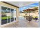 A view from inside the screened-in pool area toward the patio dining set at 1685 Garcia Ct, The Villages, FL 32159