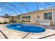 A sparkling pool with a slide and relaxing bench seating in a screened enclosure at 1685 Garcia Ct, The Villages, FL 32159