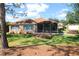 Inviting backyard featuring a screened lanai, hot tub, and lush green lawn at 17274 Se 85Th Willowick Cir, The Villages, FL 32162