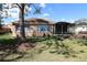 Serene backyard featuring a screened lanai, lush lawn, and beautiful landscaping at 17274 Se 85Th Willowick Cir, The Villages, FL 32162