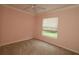 Clean bedroom featuring a ceiling fan and a bright, sunny window at 17274 Se 85Th Willowick Cir, The Villages, FL 32162