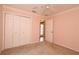 Spacious bedroom featuring a double closet and a view to the home's front door at 17274 Se 85Th Willowick Cir, The Villages, FL 32162