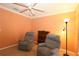 Well-lit bedroom featuring 2 lounge chairs, a ceiling fan, and a floor lamp at 17274 Se 85Th Willowick Cir, The Villages, FL 32162