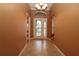 Elegant foyer features tile flooring, decorative glass door, chandelier, and arched transom window at 17274 Se 85Th Willowick Cir, The Villages, FL 32162