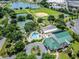 Aerial view showcasing a swimming pool, clubhouse, and various recreational facilities at 17378 Se 110Th Ter, Summerfield, FL 34491