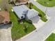 Aerial view of a home with a well-manicured lawn, showcasing the driveway and landscaping at 17378 Se 110Th Ter, Summerfield, FL 34491