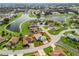 Aerial view of a home in a quiet neighborhood with a lake, showcasing its location and surroundings at 17378 Se 110Th Ter, Summerfield, FL 34491