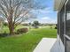 Lush backyard with lake view, showcasing the property's serene outdoor space at 17378 Se 110Th Ter, Summerfield, FL 34491