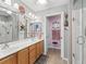 Well-lit bathroom featuring double sinks, a walk-in shower, and tile flooring at 17378 Se 110Th Ter, Summerfield, FL 34491