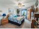 Bright bedroom boasting a cottage style with carpet, ceiling fan, and large window at 17378 Se 110Th Ter, Summerfield, FL 34491