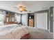 Bright bedroom with plush carpeting, a decorative ceiling fan, and ample closet space at 17378 Se 110Th Ter, Summerfield, FL 34491