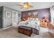 Comfortable bedroom with plush carpeting and an ensuite bathroom with a glass enclosed shower at 17378 Se 110Th Ter, Summerfield, FL 34491
