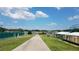 Concrete path leading to tennis courts, baseball field, trees, blue skies and landscaping at 17378 Se 110Th Ter, Summerfield, FL 34491