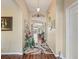 Inviting hallway with hardwood floors, decorative archways, and an abundance of decor at 17378 Se 110Th Ter, Summerfield, FL 34491