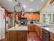 Well-equipped kitchen with stainless steel appliances, custom cabinets, and hardwood floors at 17378 Se 110Th Ter, Summerfield, FL 34491