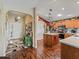 Open concept kitchen featuring hardwood floors, wood cabinets and views to the entryway at 17378 Se 110Th Ter, Summerfield, FL 34491