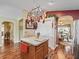 Kitchen island with hanging pot rack provides great view of the dining room at 17378 Se 110Th Ter, Summerfield, FL 34491