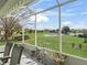This screened lanai is the perfect place to relax and enjoy the beautiful lake view and landscaping at 17378 Se 110Th Ter, Summerfield, FL 34491