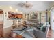 Bright living room showcasing an open layout with wood floors and bar seating looking into the kitchen at 17378 Se 110Th Ter, Summerfield, FL 34491