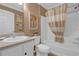 Bathroom featuring a bathtub with shower, a toilet, and a vanity sink at 1755 Lakewood Dr, The Villages, FL 32162